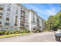 Attractive condo building with balconies, manicured shrubs, and parking area at 3201 Lenox Ne Rd # 23, Atlanta, GA 30324