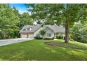 Charming home with a two-car garage, manicured lawn, and lush landscaping provides great curb appeal at 17 Sassafras Ne Trl, Cartersville, GA 30121