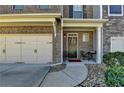 Charming front porch and entrance with well-maintained landscaping, and a two-car garage at 2639 Cooper Brook Dr, Snellville, GA 30078
