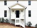 A black front door framed by white trim and a covered porch adds classic charm at 3663 Heatherwood Ne Dr, Marietta, GA 30066