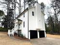 A well maintained two-car garage and white siding highlight this home's exterior at 3663 Heatherwood Ne Dr, Marietta, GA 30066