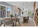 Bright, modern kitchen with stainless steel appliances, island with seating, and adjacent dining area at 462 Connally Se St, Atlanta, GA 30312
