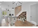 Contemporary kitchen featuring a large island, modern lighting, wine rack, and hardwood floors at 462 Connally Se St, Atlanta, GA 30312