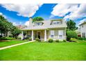 Beautiful home with a covered front porch and lush landscaping, offering a welcoming and serene atmosphere at 2763 Nautical Way, Villa Rica, GA 30180