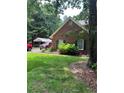 Brick exterior with green shutters, complemented by a well-kept lawn and mature trees at 50 Ranger Se Rd, Cartersville, GA 30121