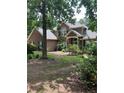 Traditional home with brick and siding exterior, showcasing a well-manicured lawn and mature trees at 50 Ranger Se Rd, Cartersville, GA 30121