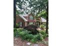 Charming home with brick and siding exterior, complemented by well-maintained landscaping and mature trees at 50 Ranger Se Rd, Cartersville, GA 30121