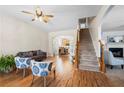 Cozy living room featuring a staircase, fireplace, hardwood floors, and archway leading to the dining area at 240 Daisy Cir, Mcdonough, GA 30252