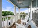 Inviting covered porch featuring a ceiling fan, white rocking chairs, and a view of the street at 240 Daisy Cir, Mcdonough, GA 30252