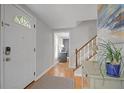 Inviting entryway with hardwood floors and view of staircase at 9470 Hillside Dr, Roswell, GA 30076
