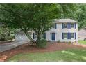 Traditional two-story home with white siding and blue shutters at 9470 Hillside Dr, Roswell, GA 30076