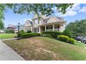 Lovely two-story home with a well-maintained lawn, lush green shrubs, and inviting curb appeal at 4526 Meadow Club Dr, Suwanee, GA 30024