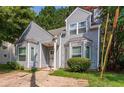 Charming home featuring a two-story facade, gray siding, bay windows, and a concrete driveway at 620 Waynes Se Ct, Atlanta, GA 30354