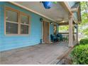 Inviting covered front porch with comfortable seating, ceiling fan, and decorative hanging plants at 730 Brownwood Se Ave, Atlanta, GA 30316