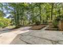 Long driveway and parking area surrounded by mature trees at 119 Castlewood Rd, Tyrone, GA 30290