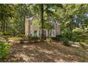 Two-story home with brick and siding exterior, surrounded by mature trees at 119 Castlewood Rd, Tyrone, GA 30290