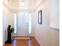 Bright foyer with hardwood floors, white trim, and a view of the front door at 175 Robin Ct, Fayetteville, GA 30215