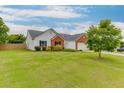 Classic one-story home features a lush green lawn and a welcoming facade at 4735 Widgeon Way, Cumming, GA 30028