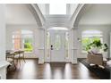 Bright foyer with soaring ceilings, hardwood floors, and an ornate glass front door at 1952 Sugarstone Dr, Lawrenceville, GA 30043