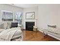 Comfortable living room featuring hardwood floors, fireplace, and a stylish sectional sofa at 220 Ashley Se Ln # 19, Smyrna, GA 30080