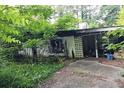 Side view of an unkempt home showcasing its exterior damage and neglected condition at 2440 Andy Mountain Rd, Villa Rica, GA 30180