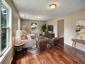 Bright living room with hardwood floors, a comfortable sofa, and windows offering pleasant views at 1625 Orlando Sw St, Atlanta, GA 30311