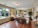 Inviting living room featuring hardwood floors, a stylish sofa, and large windows for natural light at 1625 Orlando Sw St, Atlanta, GA 30311