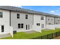 New townhome backyards with white fence and small patio at 318 Sound Cir, Stockbridge, GA 30281