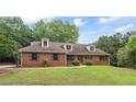 Charming one-story brick home with a well-manicured lawn and mature trees at 103 Seabolt Dr, Locust Grove, GA 30248