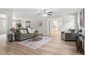 Open-concept living room with hardwood floors and lots of natural light streaming through the windows at 103 Seabolt Dr, Locust Grove, GA 30248