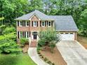 Attractive two-story brick home featuring a two-car garage and lush green surroundings at 135 Crimson Rdg, Tyrone, GA 30290