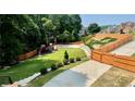 Expansive backyard featuring a playground area and lush green lawn, perfect for outdoor activities and Gathering enjoyment at 3499 Lake Mill Rd, Buford, GA 30519