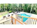 Inviting outdoor swimming pool surrounded by a spacious patio, lounge seating, and lush greenery for ultimate relaxation at 3499 Lake Mill Rd, Buford, GA 30519