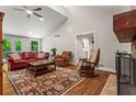Spacious living room with a vaulted ceiling, stone fireplace, and outside access at 970 Pine Grove Pointe Dr, Roswell, GA 30075