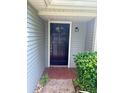 Inviting front entrance with a modern black door and manicured landscaping at 10630 Worthington Hills Mnr, Roswell, GA 30076