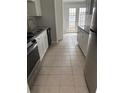 Bright kitchen features stainless steel appliances and white cabinets at 10630 Worthington Hills Mnr, Roswell, GA 30076