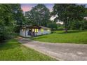 Serene view of the home and driveway nestled on a lush, tree-filled lot at dusk at 1769 W Austin Rd, Decatur, GA 30032