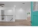 Inviting entryway with stylish railing, light floors, and bright blue front door at 2128 Kimberly Rd, Atlanta, GA 30331