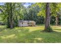 Quaint renovated home situated on a green lawn, surrounded by mature trees at 2128 Kimberly Rd, Atlanta, GA 30331