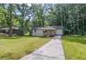Newly renovated bungalow boasting a large grassy front yard with mature shade trees at 2128 Kimberly Rd, Atlanta, GA 30331