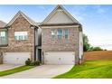 Townhome with a two-car garage, attractive landscaping, and private driveway at 2629 Irwell Way, Lawrenceville, GA 30044