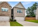 Townhome boasts a two-car garage, and well-maintained landscaping at 2629 Irwell Way, Lawrenceville, GA 30044