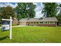Charming one story home with a well-manicured lawn and mature trees at 5254 Corinth Dr, Stone Mountain, GA 30087