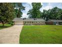 Lovely home on a sprawling lawn with mature trees and ample parking at 5254 Corinth Dr, Stone Mountain, GA 30087
