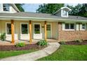 Welcoming front porch with natural wood columns and a vibrant green door at 5254 Corinth Dr, Stone Mountain, GA 30087