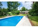 Refreshing backyard pool with lounge area and lush greenery at 5254 Corinth Dr, Stone Mountain, GA 30087