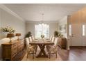 Formal dining room with hardwood floors, elegant lighting, and seating for eight at 6528 Carriage Ln, Stone Mountain, GA 30087