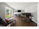 Bright living room with a bay window, dark hardwood floors, and modern furnishings at 1373 Brawley Ne Cir, Brookhaven, GA 30319