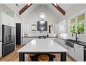 Spacious kitchen featuring an island with seating, white cabinets, and stainless steel appliances at 2490 S Carroll S St, Villa Rica, GA 30180