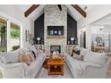 Comfortable living room with vaulted ceiling, exposed beams, and a large stone fireplace at 2490 S Carroll S St, Villa Rica, GA 30180